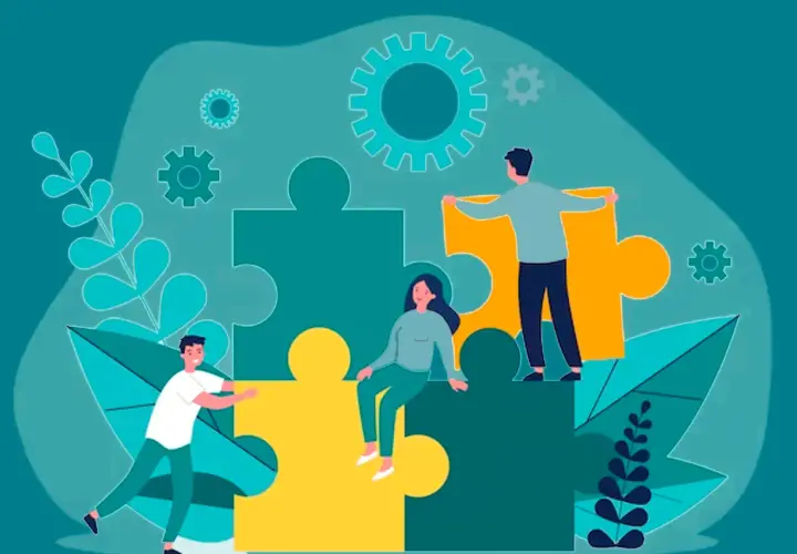 Personas trabajando juntas para armar un rompecabezas gigante, simbolizando el aprendizaje cooperativo y la colaboración.