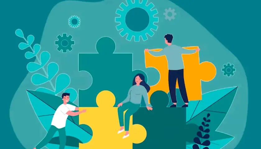 Personas trabajando juntas para armar un rompecabezas gigante, simbolizando el aprendizaje cooperativo y la colaboración.