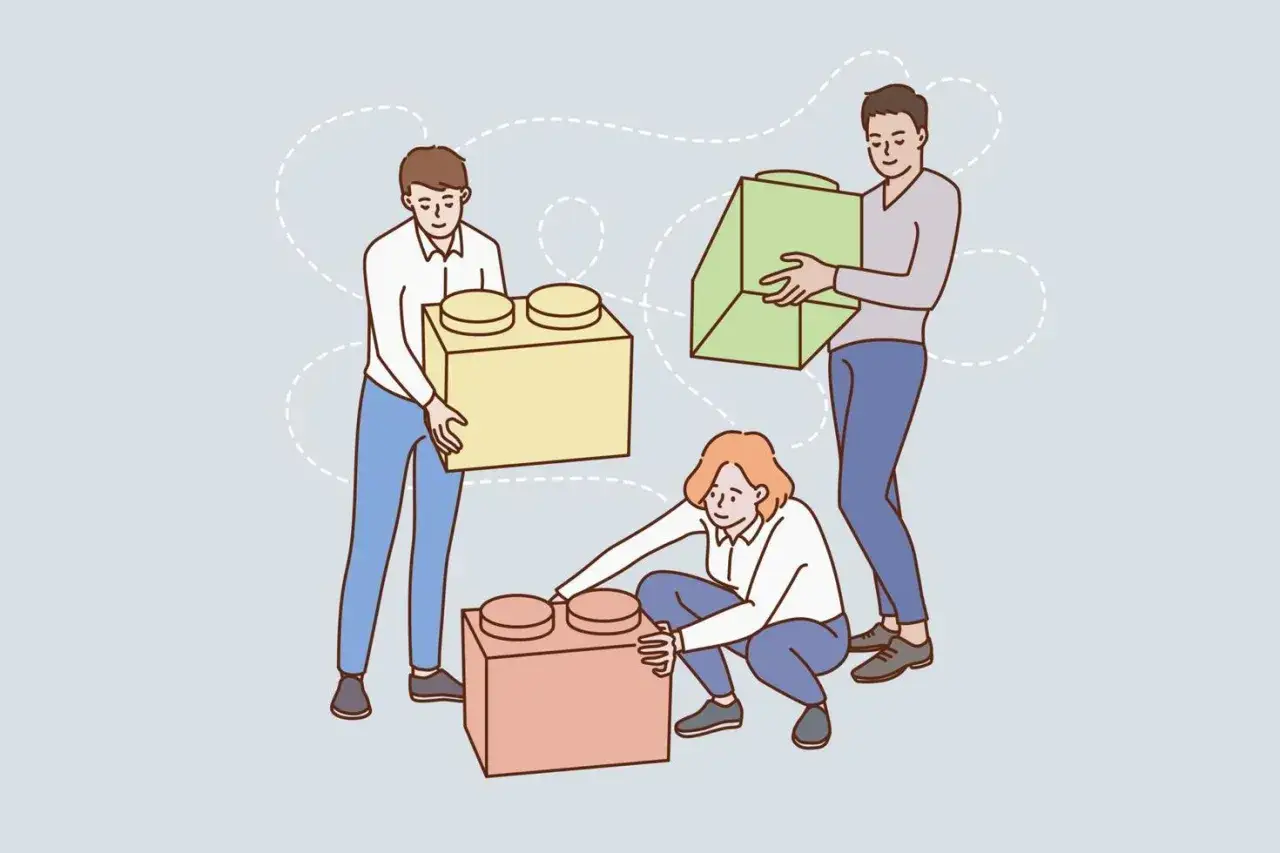 Tres personas construyen algo juntas, creando una conexión emocional.